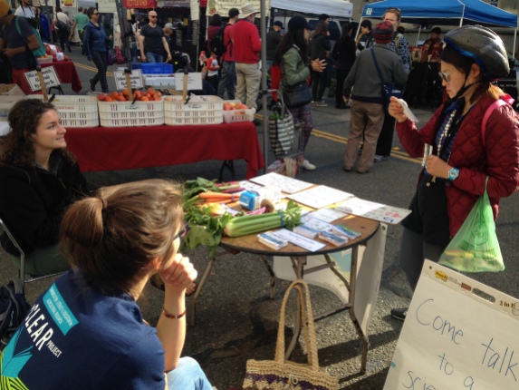 Downtown Berkeley Farmers' Market - sharing information with a visitor